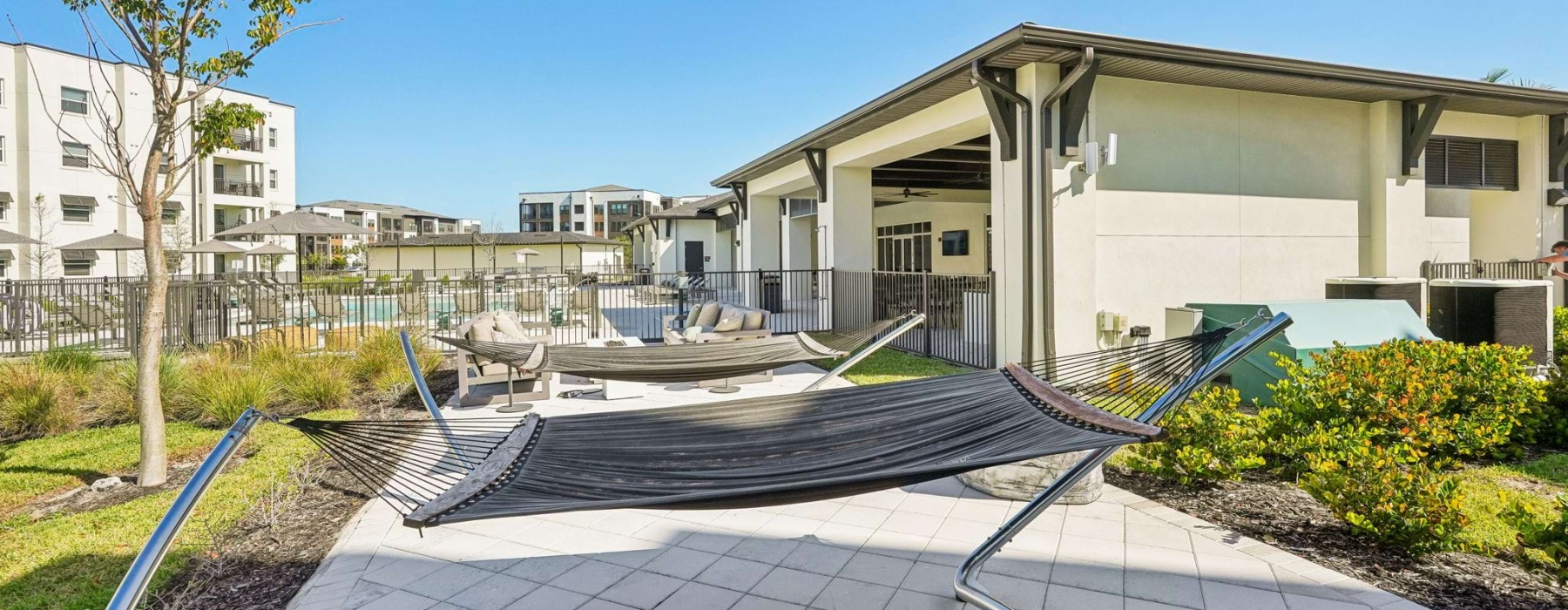 A hammock on a patio by the pool