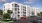 a building with cars parked in front